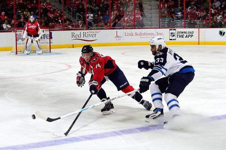 John Carlson of the Washington Capitals and Dustin Byfuglien of the Winnipeg Jets battle for the puck at Verizon Center on Thursday in Washington, D.C.