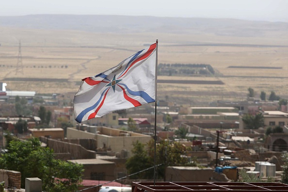The Iraqi Christian Assyrian flag flutters over the town of al-Qosh, 45 kilometres north of Mosul, on September 19, 2014.
