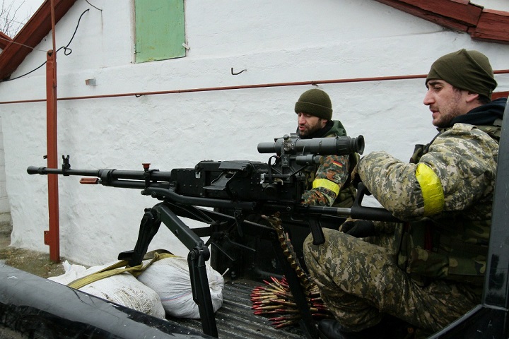 Ukrainian servicemen prepare their ammunition at a position on the frontline near the southern Ukrainian city of Mariupol on January 26, 2015.