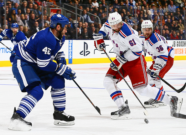 Roman Polak #46 of the Toronto Maple Leafs tries to stop Rick Nash #61 of the New York Rangers during NHL action at the Air Canada Centre February 10, 2015 in Toronto, Ontario, Canada.