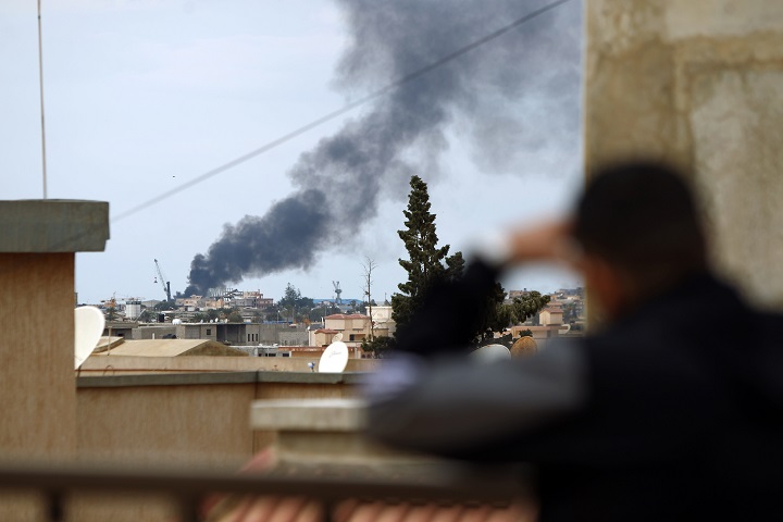 Smoke rises from the port of the eastern Libyan city of Benghazi on February 14, 2015.