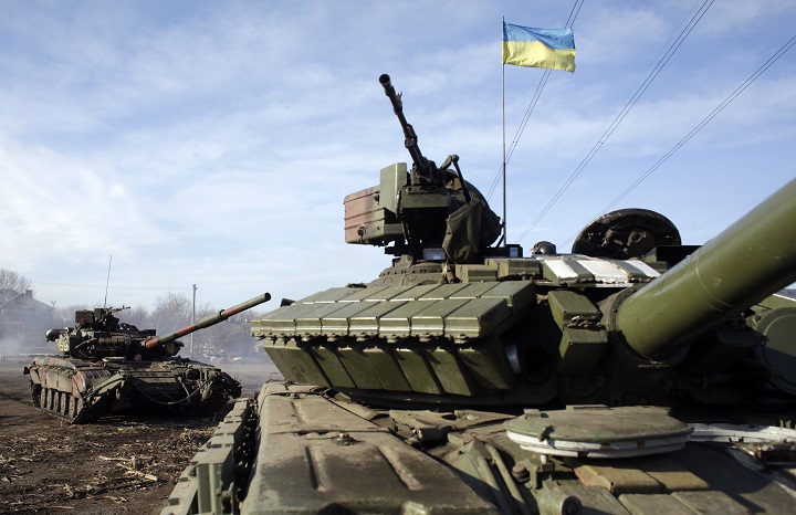 Ukrainian army tanks ride through a checkpoint near Horlivka, in the region of Donetsk, on February 23, 2015. 