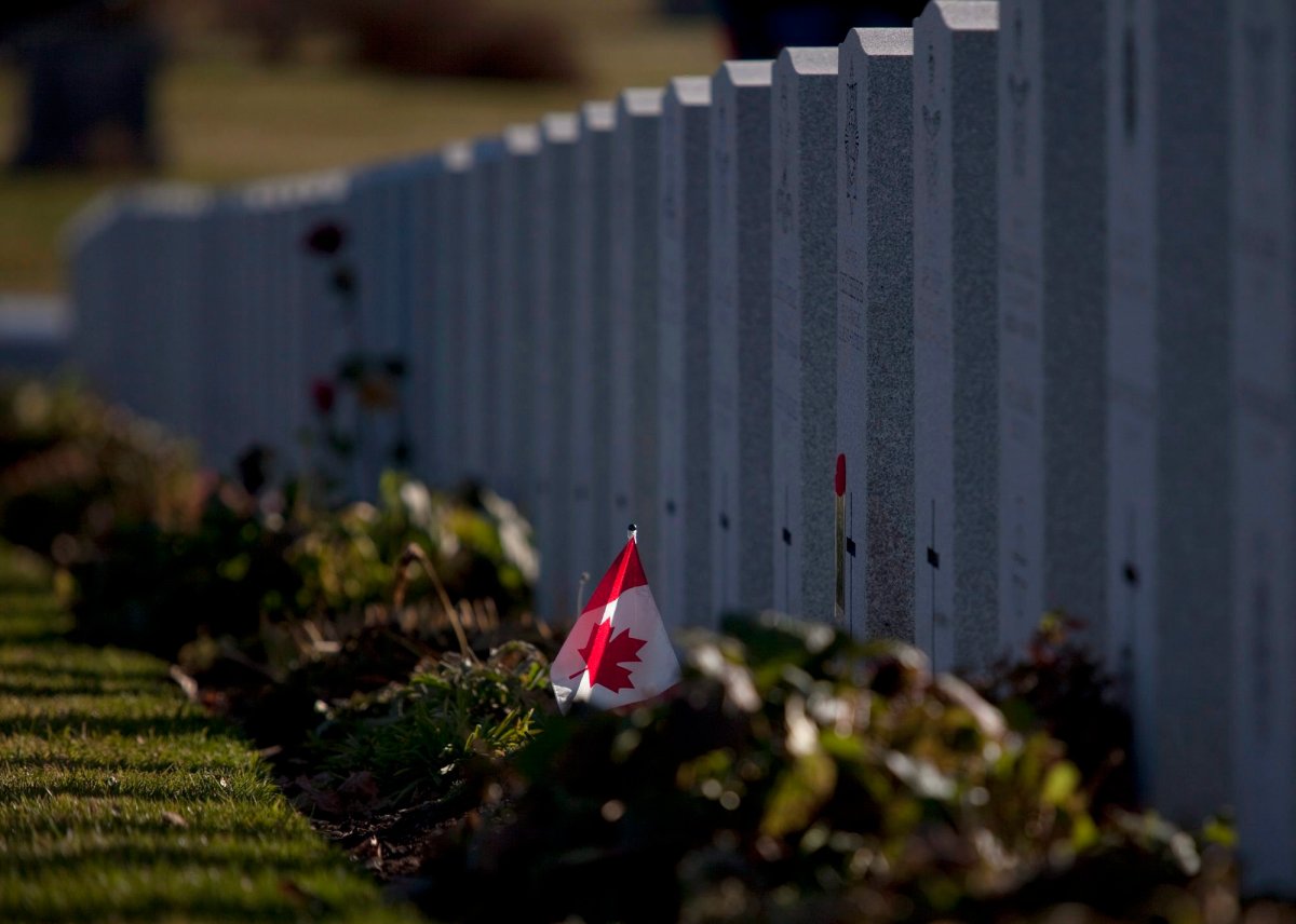 A Canadian flag is seen in front of a grave at the National Military Cemetery in Beechwood Cemetery on Remembrance Day in Ottawa on Wednesday, Nov. 11, 2009.