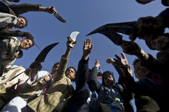 Supporters of Houthi Shiites wave traditional daggers and dance as they celebrate the fourth anniversary of the uprising in Sanaa, Yemen, Wednesday, Feb. 11, 2015. 