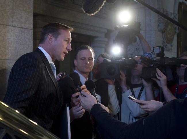 Justice Minister Peter MacKay speaks with the media following question period outside the House of Commons on Parliament Hill in Ottawa on Friday, February 6, 2015. 