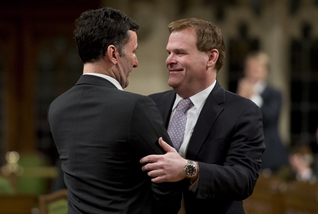 NDP foreign affairs critic Paul Dewar hugs former foreign affairs minister John Baird, who he said once said it was up to the Iraqis to fix the problem with ISIS. 