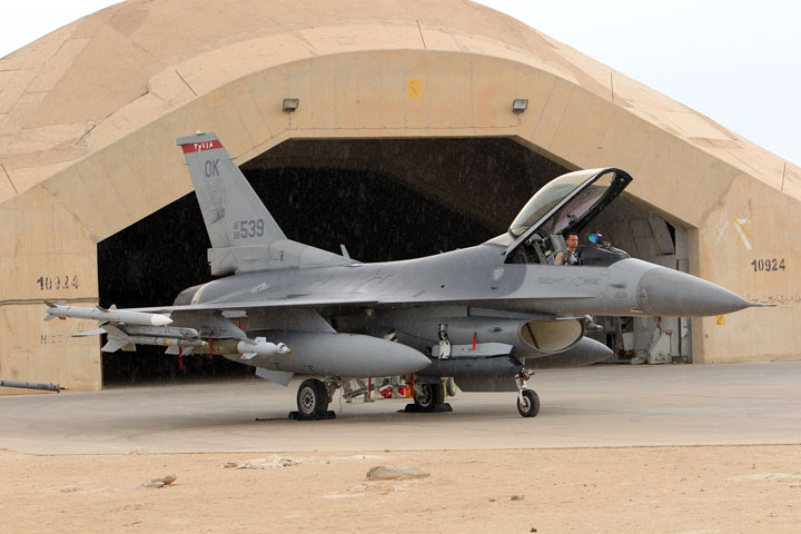 A pilot sits in a US F16 jet fighter at the al-Asad Air Base in this November 1, 2011 file photo.  