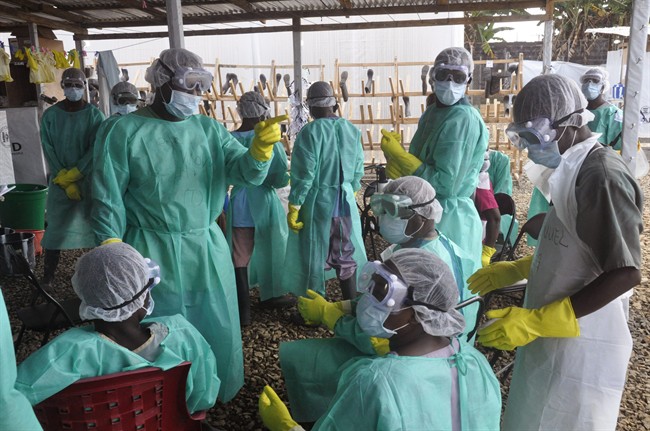Health care workers inside a USAID, funded Ebola clinic with their Ebola virus protective gear in Monrovia, Liberia, Friday, Jan. 30, 2015.