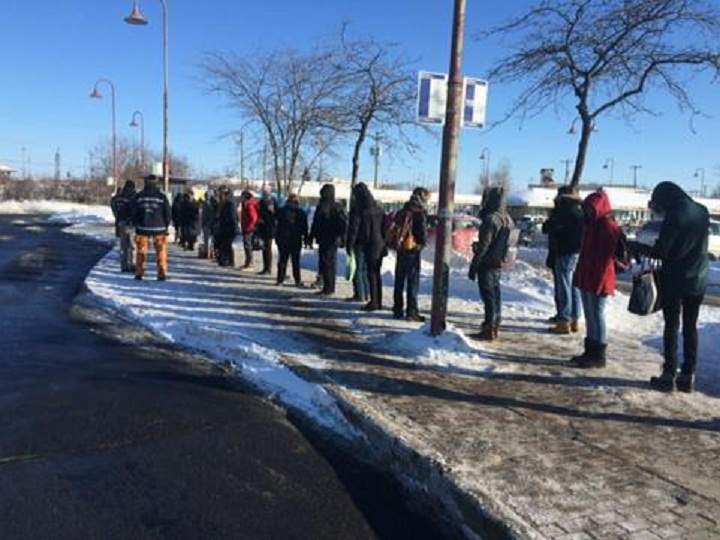 The CP Rail strike action has affected Montreal commuters, pictured here waiting for replacement buses on February 16, 2015.