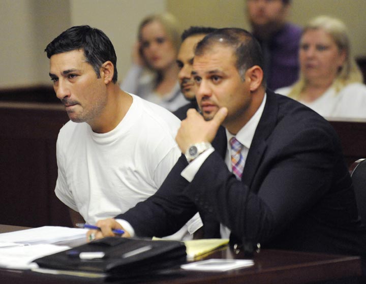 In this July 10, 2014, file photo, Bassel Abdul Saad, left, sits with his attorney Ali Hammoud, during his arraignment in Livonia, Mich. Saad, who is charged in the one-punch killing of referee John Bieniewicz during a soccer game, has agreed to a plea deal with prosecutors in which he would serve 8-15 years in prison. 