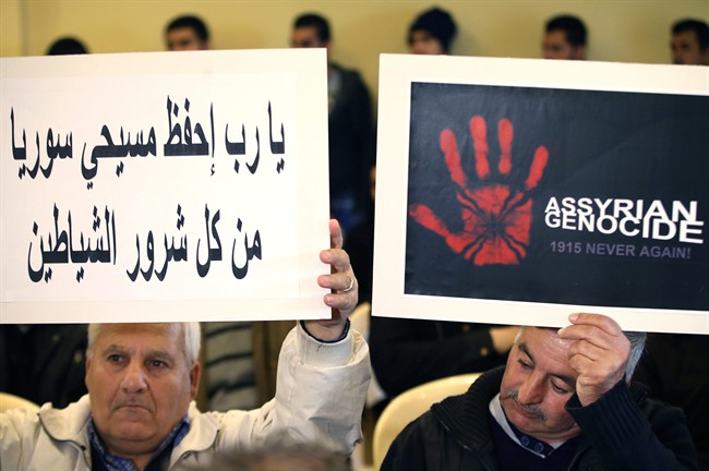 Assyrian citizens hold placards during a sit-in for abducted Christians in Syria and Iraq, at a church in Sabtiyesh area east Beirut, Lebanon, Thursday, Feb. 26, 2015.