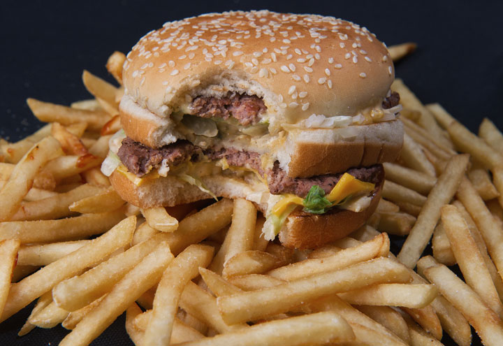 A photo of a partially eaten McDonalds' Big Mac hamburger atop French fries, November 2, 2010.