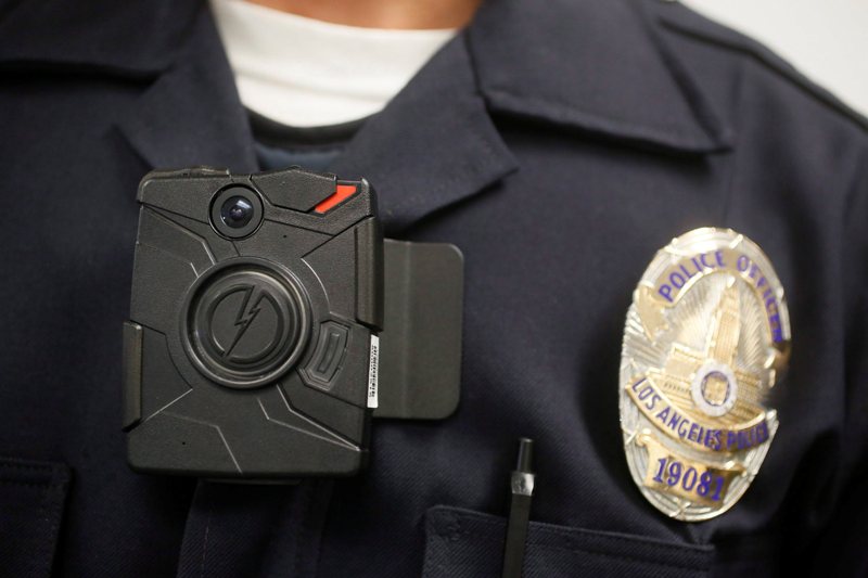 This Jan. 15, 2014, file photo, a Los Angeles Police officer wears an on-body cameras during a demonstration for media in Los Angeles.  
