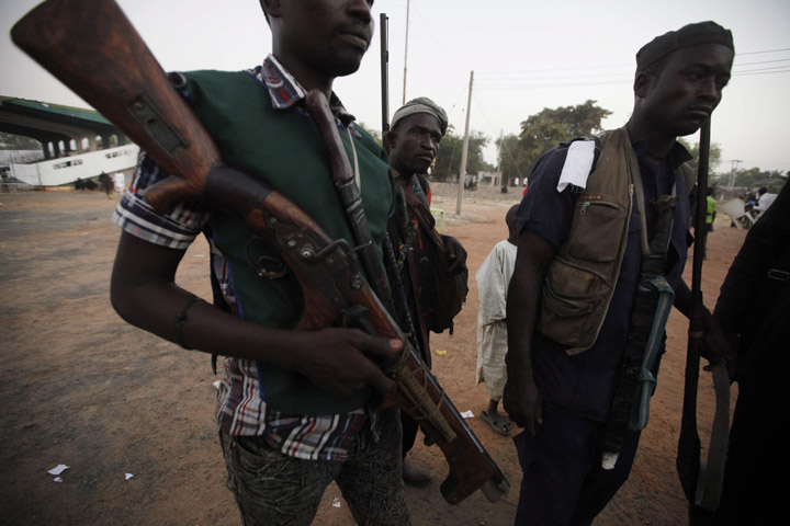 Vigilantes and local hunters armed with locally made guns gather before they go on patrol in Yola, Nigeria in Nov. 2014.