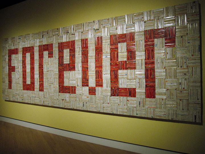 This Sept. 27, 2014 photo shows a solid wall of 4,000 paperback romance novels spelling out the word "FOREVER" in an art installation at Crystal Bridges Museum of American Art in Bentonville, Ark. The work by John Salvest was part of a major contemporary art show at the museum in late 2013. Salvest said there was an "underlying sadness" to collecting the discarded books from thrift shops in an era when fewer people read physical books.