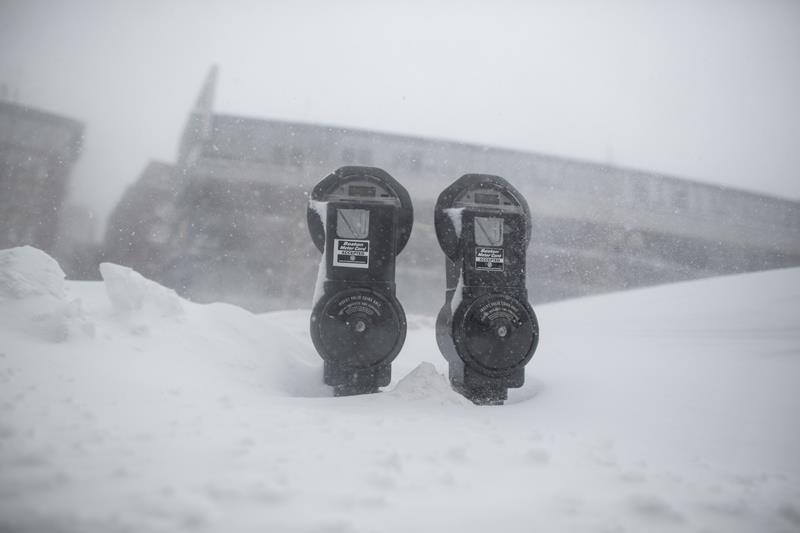 Snow nearly reaches the top of parking meters on Surface Rd. during winter storm Neptune which dropped over a foot of snow February 15, 2015 in Boston, Massachusetts.