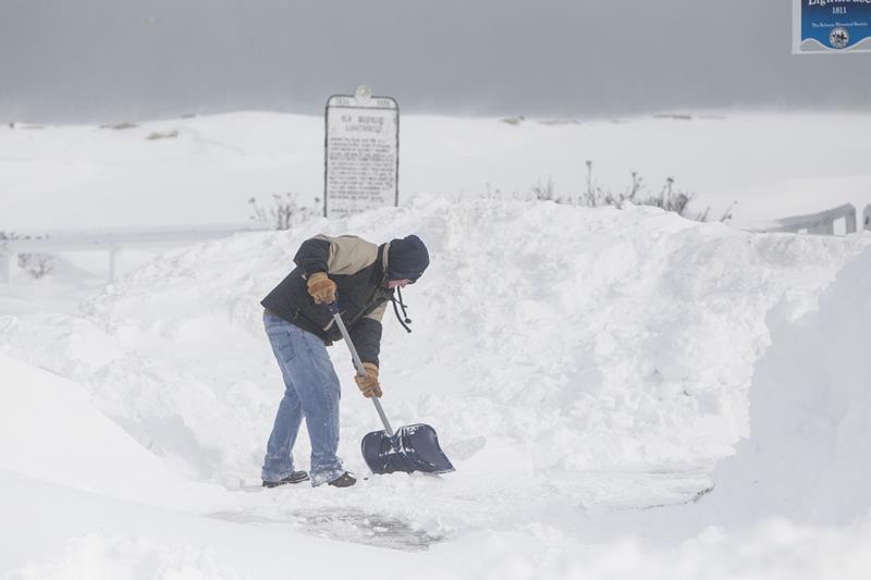 A man shovels snow on Lighthouse Rd. during winter storm Neptune which dropped over a foot of snow February 15, 2015 in Scituate, Massachusetts.