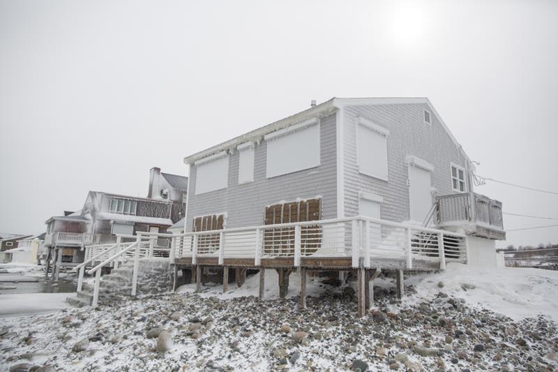 A boarded up oceanfront house on Oceanside Dr. during winter storm Neptune which dropped over a foot of snow February 15, 2015 in Scituate, Massachusetts.This is the fourth major storm to hit the New England region that has already seen more than 6 feet of snow in some areas.