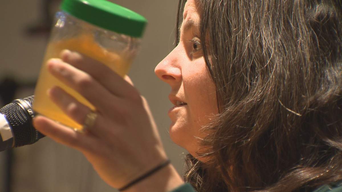 A Pointe-Claire resident showed city council members the brown water flowing from taps on Highgate Avenue at a council meeting on February 3, 2014.