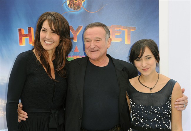 FILE - In this Nov. 13, 2011 file photo, Susan Schneider, from left, Robin Williams, and Zelda Williams arrive at the premiere of "Happy Feet Two" at Grauman's Chinese Theater, in Los Angeles. Williams' children and wife are fighting over the late comedian's estate in a California court. In papers filed in December 2014 in San Francisco Superior Court, Williams' wife, Susan, accuses the comedian's children from two previous marriages of taking items without her permission. (AP Photo/Katy Winn, File).
