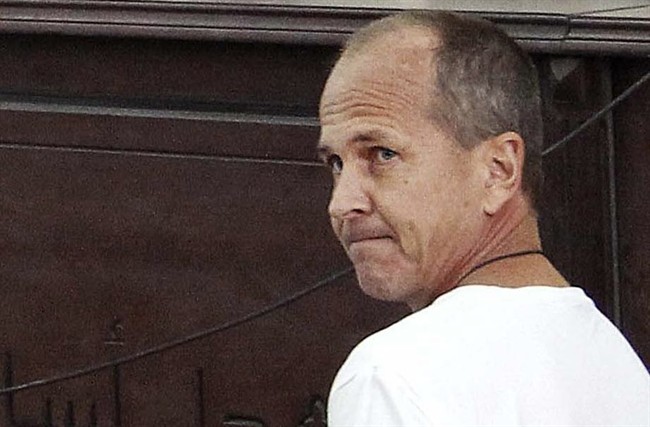 FILE - In this Monday, March 31, 2014 file photo, Al-Jazeera English correspondent Peter Greste, appears in court along with several other defendants during their trial on terror charges, in Cairo, Egypt. 