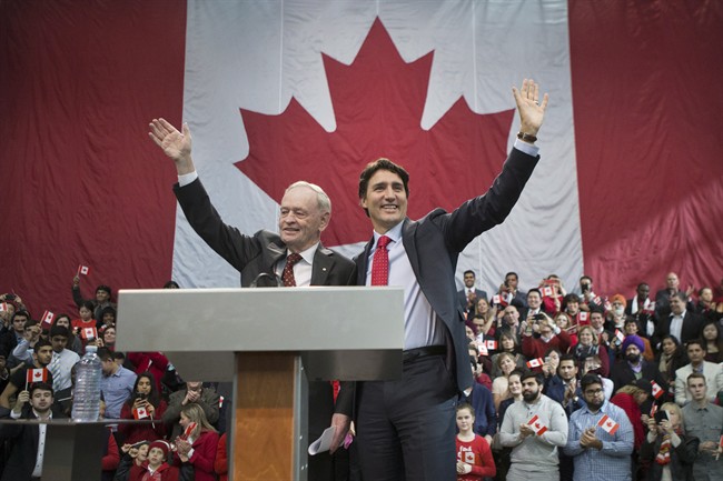 Liberal Leader Justin Trudeau (right) and former prime minister Jean Chretien stand together on stage at an event to celebrate the 50th Anniversary of the Canadian Flag, in Mississauga Ont., on Sunday February 15 2015.