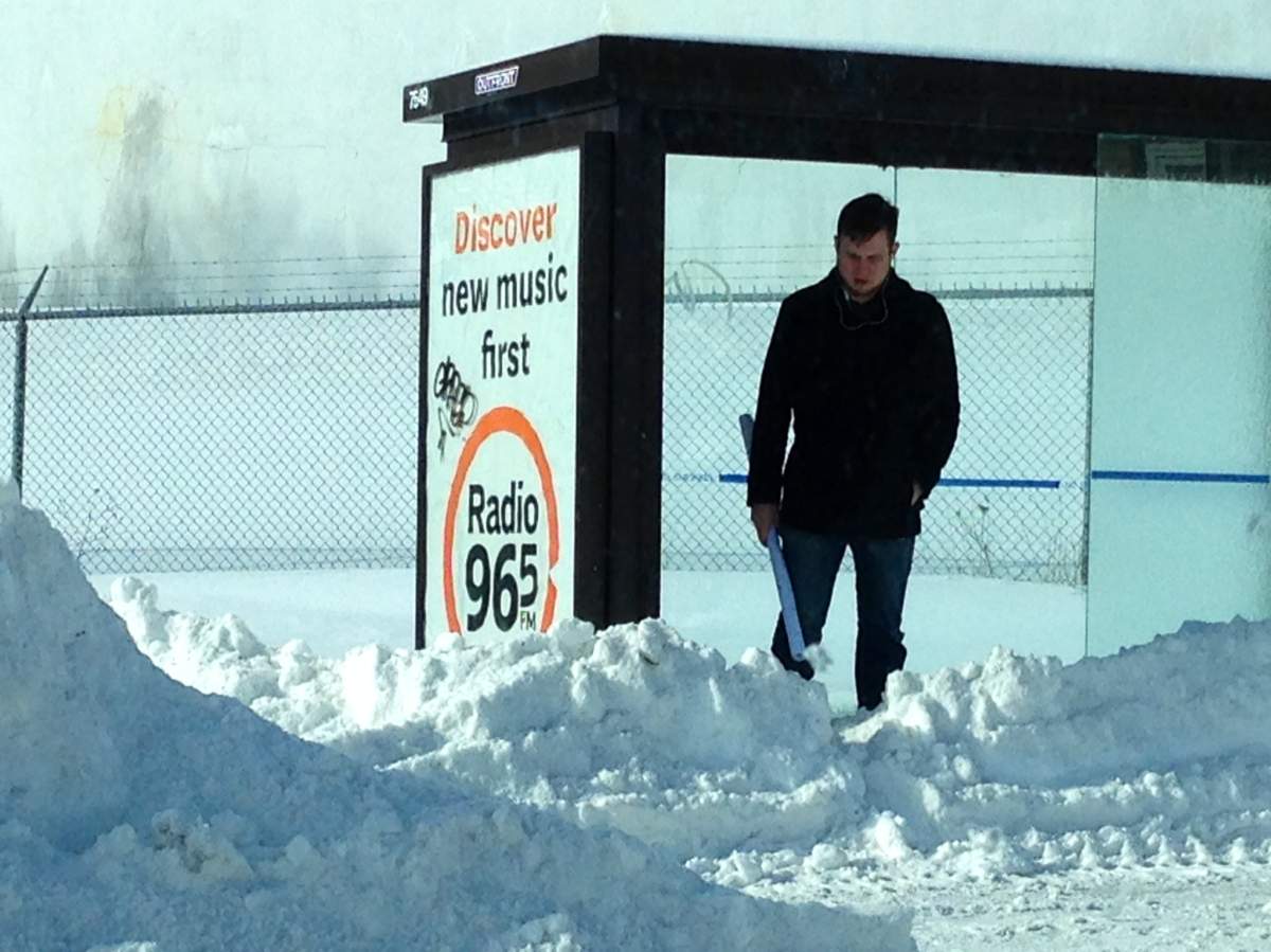 A commuter waits for a Halifax Transit bus following blast of winter