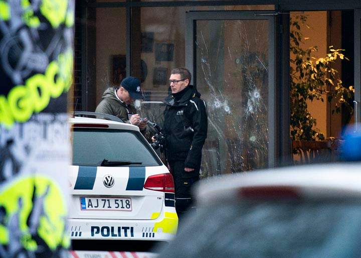 Bullet holes are seen in the window of a Copenhagen cafe where a gunman opened fire Saturday, Feb. 14, 2015, in what is seen as a likely terror attack against a free speech event organized by an artist who had caricatured the Prophet Mohammad. 
