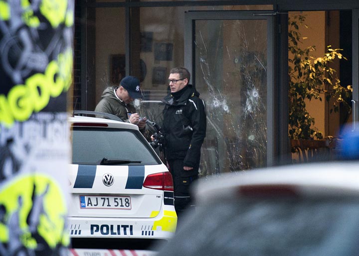Bullet holes are seen in the window of a Copenhagen cafe where a gunman opened fire Saturday, Feb. 14, 2015, in what is seen as a likely terror attack against a free speech event organized by an artist who had caricatured the Prophet Mohammad. 