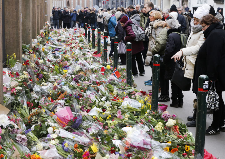 Flowers are laid in front of the synagogue in Copenhagen, Denmark, Tuesday, Feb. 17, 2015, following recent attacks. 