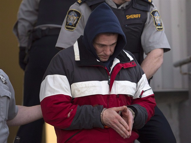 Christopher Burton Phillips is escorted from provincial court in Dartmouth, N.S. on Friday, Jan. 23, 2015.