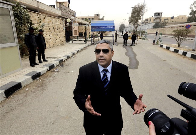Canadian Al Jazeera English journalist Mohamed Fahmy, speaks to the media outside a court before his retrial in Cairo, Egypt, on Feb. 23, 2015. 
