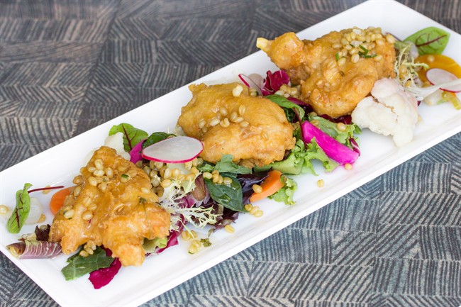 Crispy fried chicken thighs with spiced honey, wheatberries and cauliflower a la Grecque from the 2013 Summerlicious menu at the O&B Cafe Grill at Bayview Village in Toronto is seen in this undated handout photo.