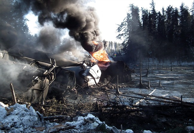 This Feb. 16, 2015 photo provided by the Transportation Safety Board of Canada shows a ruptured tank car on fire after a crude oil train derailment south of south of Timmins, Ontario. An investigation into the recent derailment in Ontario of a freight train carrying crude oil suggests new safety standards introduced after the Lac-Megantic, Que., tragedy are inadequate, Canada's transport investigator said Monday.