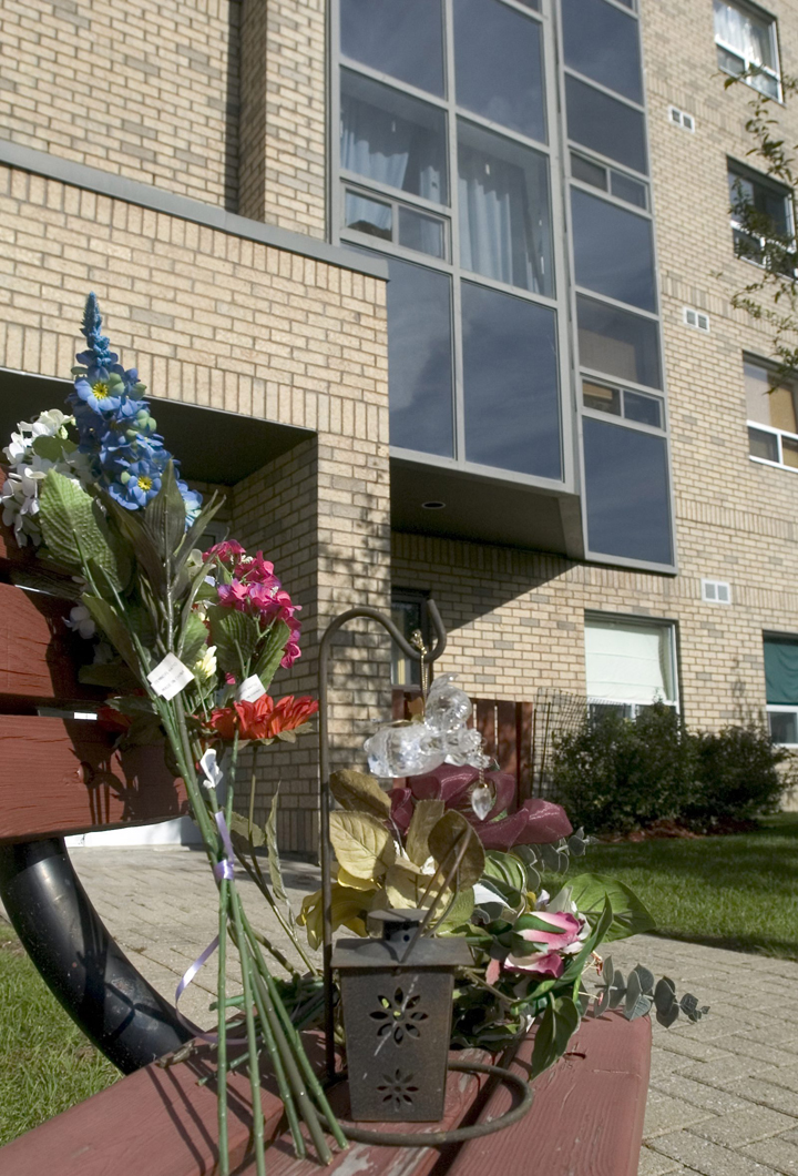 A small floral tribute has started outside the Coulter St. apartment building in Barrie, Ont., Thursday, Oct.5, 2006 where two little girls, Sophia and Serena Campione were found dead on Wednesday morning.