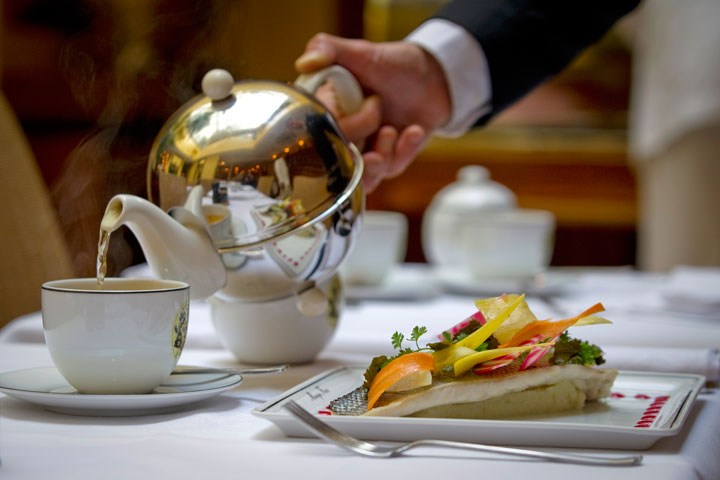 A waiter serves tea at the restaurant of French luxury Tea House, Mariage Freres, on October 10, 2011 in Le Marais area, central Paris.