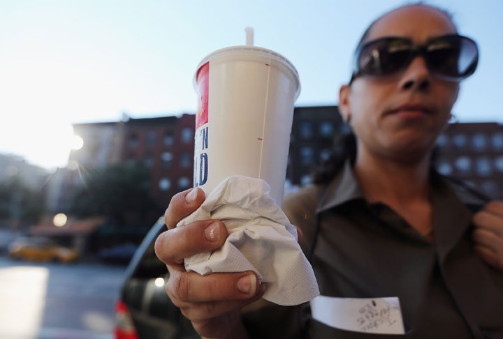 Jasmine Batista displays a 21-ounce soda she purchased at McDonalds in Manhattan after the New York City Board of Health voted to ban the sale of large sugary drinks at restaurants and concessions on September 13, 2012 in New York City.