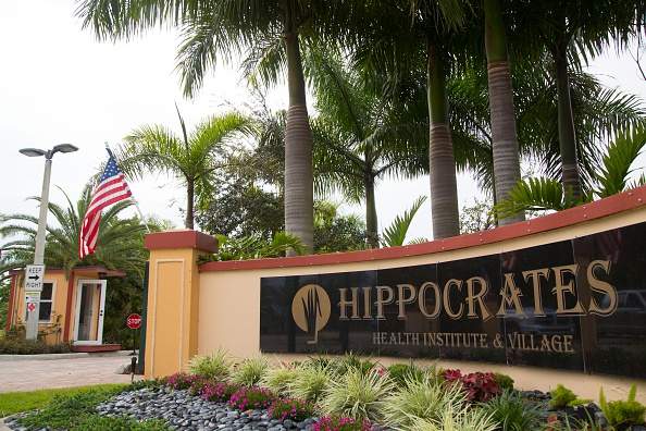 The main entrance and security guard house at the walled compound of the Hippocrates Health Institute in Florida.
