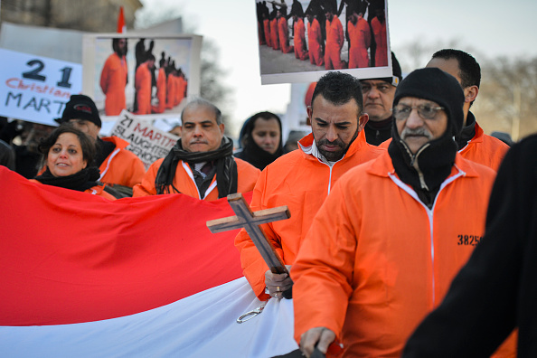 A group of Egyptian Coptic Christians, including Amer Sabet, holding a cross, march from the White House toward the U.S. Capitol in remembrance of 21 Egyptian Coptic Christians recently beheaded in Libya by Islamic State (ISIS), on Monday, February 24, 2015, in Washington, DC.  