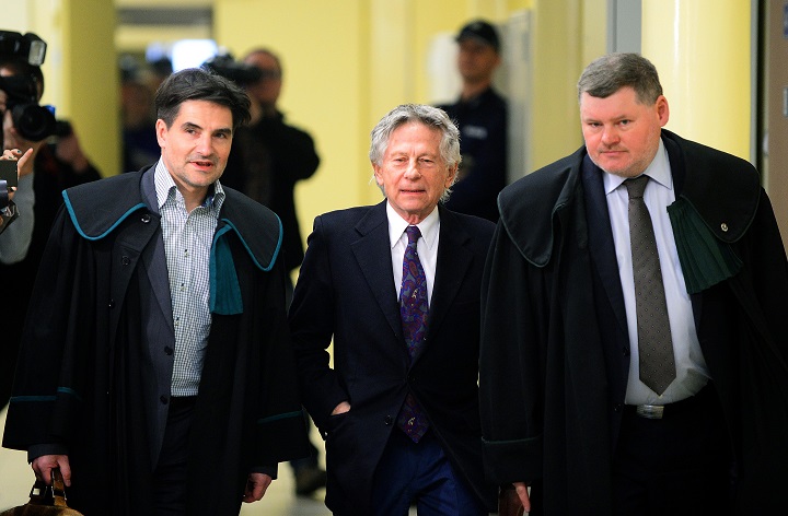 French-Polish film director Roman Polanski (C) is accompanied by his lawyers as he arrives for a hearing at the regional court in Krakow on February 25, 2015. The court is to decide whether to extradite the Oscar-winning director to the United States for sentencing on charges that he raped a 13-year-old girl in 1977.   