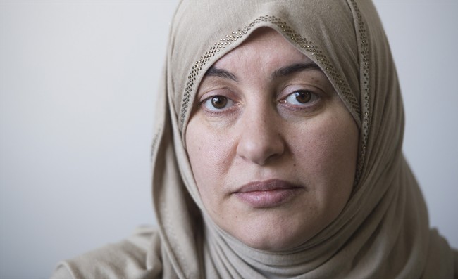 Wearing the Hijab when she went to court, Rania El-Alloul poses for a photograph at her home in Montreal, Saturday, February 28, 2015. 