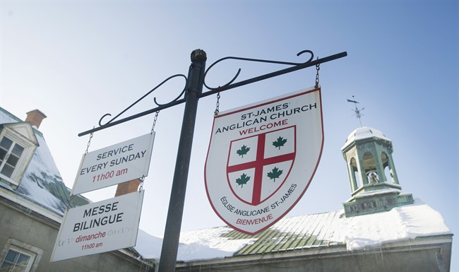 Signs in English and French hang outside St. James Anglican Church in Trois-Rivières, Que., Sunday, January 25, 2015.