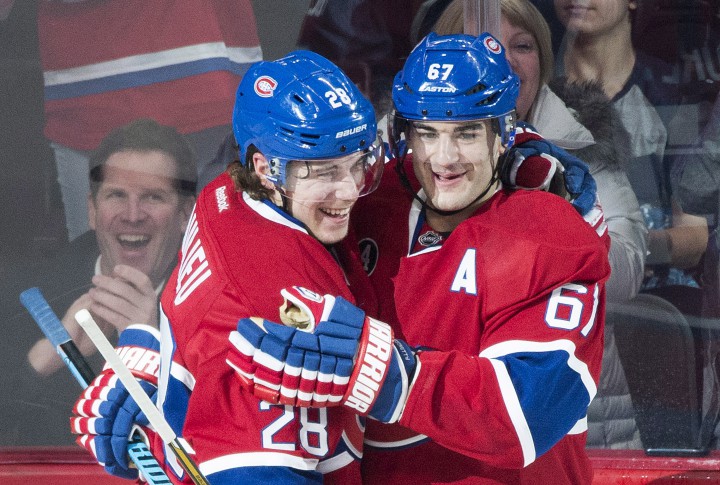 Montreal Canadiens' Max Pacioretty (67) celebrates with teammate Nathan Beaulieu after scoring against the Columbus Blue Jackets during first period NHL hockey action in Montreal, Saturday, February 21, 2015.