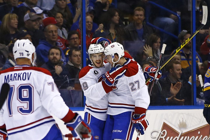 Montreal Canadiens' Michael Bournival, center, and Alex Galchenyuk, right, celebrate after scoring a goal against the St. Louis Blues during the second period of an NHL hockey game Tuesday, Feb. 24, 2015, in St. Louis.