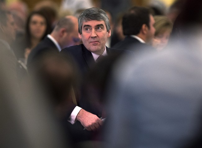 Nova Scotia Premier Stephen McNeil listens to his introduction as he waits to deliver his state of the province address to the Chamber of Commerce in Halifax on Feb. 11, 2015.
