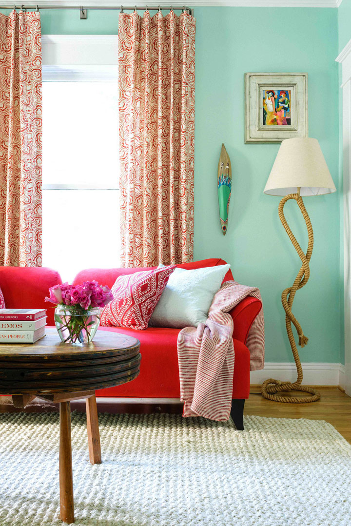 In this photo provided by Brian Patrick Flynn/HGTV.com, a den designed by Flynn showcases a fresh, feminine drapery fabric by Tilton Fenwick and a less expected feminine color scheme of mint green and fire engine red.