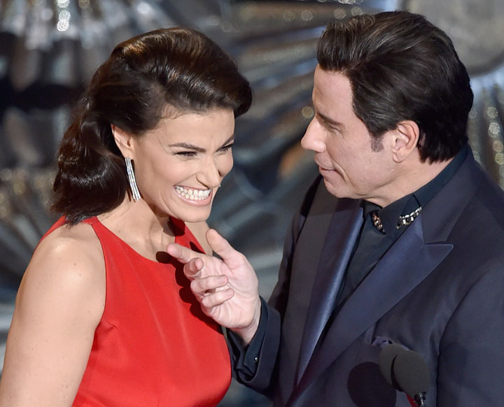Actress Idina Menzel and actor John Travolta speak onstage during the 87th Annual Academy Awards at Dolby Theatre on February 22, 2015 in Hollywood, California.