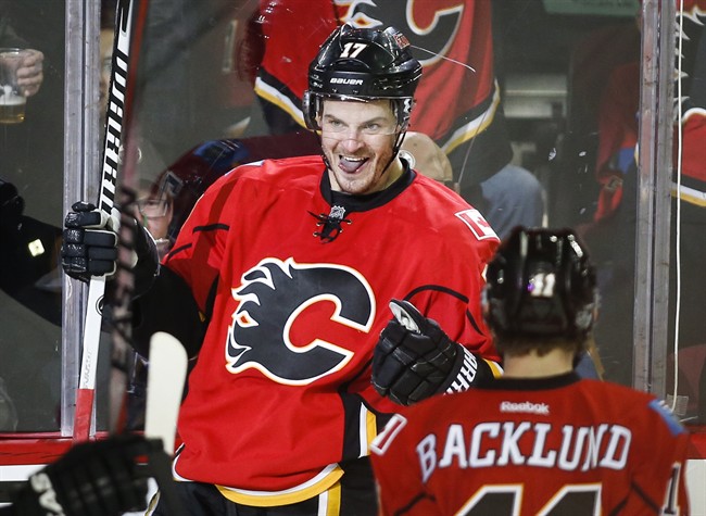 Calgary Flames' Lance Bouma celebrates his game-winning goal with teammates during third period NHL hockey action against the Edmonton Oilers in Calgary, Saturday, Jan. 31, 2015.