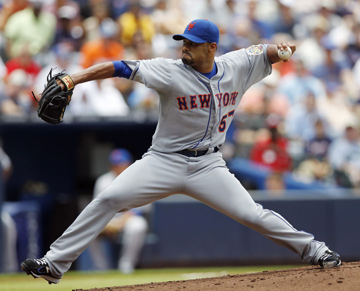In this Juy 15, 2012, file photo, New York Mets starting pitcher Johan Santana works in a baseball game against the Atlanta Braves in Atlanta. The Toronto Blue Jays have signed two-time Cy Young winner Santana to a minor league contract, hoping the former ace can make it back to the majors. 