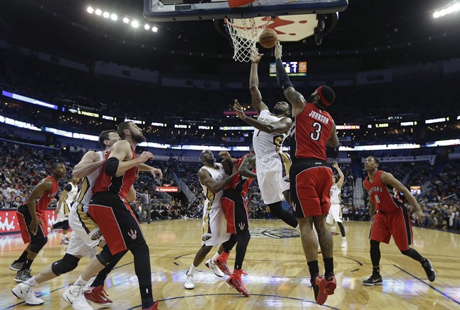 New Orleans Pelicans guard Tyreke Evans (1) goes to the basket against Toronto Raptors forward James Johnson (3) in the first half of an NBA basketball game in New Orleans, Monday, Feb. 23, 2015.